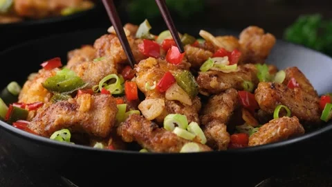 Picking salt and pepper pork loin with herbs from a bowl using a chopstick Stock Footage 171135946