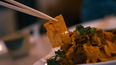 Picking slice of Chinese beef intestine with Chopsticks Stock Footage 90522422