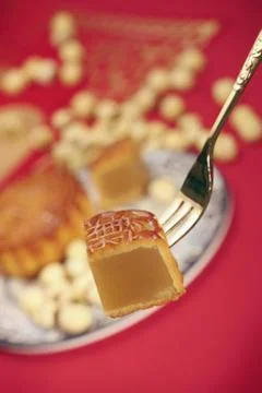 Picking up a slice of mooncake with fork Stock Photos