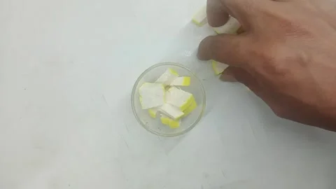 Picking Sliced Yellow Tofu and Placing into Glass Bowl Stock Footage 334130729