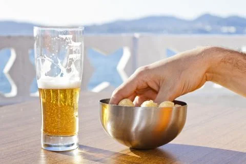Picking snacks with beer. Stock Photos