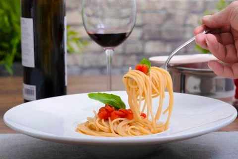 Picking up some spaghetti from a dish Stock Photos