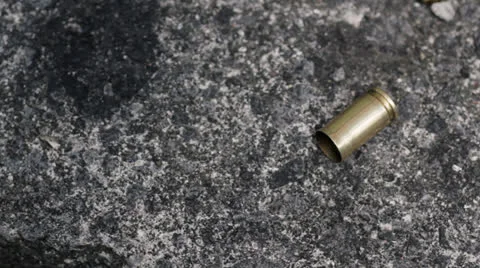 Picking up spent bullet case Stock Footage 23548103