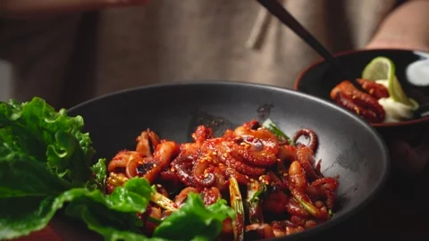 Picking Spicy Stir Fried Octopus with Chopsticks 動画素材 334832782