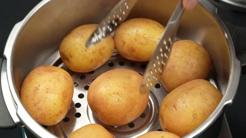 Picking Steamed Potatoes from Cooker Pot with Metal Tongs Stock Footage 343932927