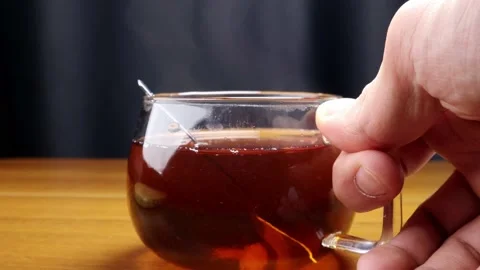 Picking up tea from the table with male hand 스톡 동영상 184601445