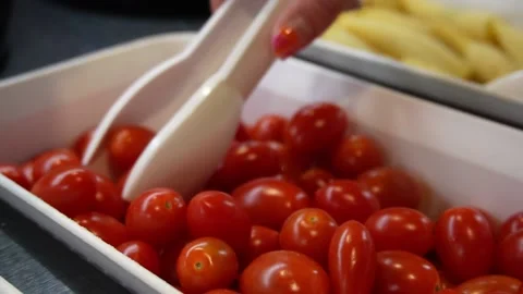 Picking tomatoes at salad bar Stock Footage 228024461