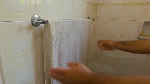 Picking up a towel that was lying in the bathroom Stock Footage 168635218