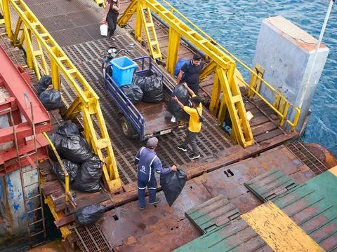 Picking up trash from the ferry Stock Photos