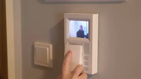 Picking up the videophone intercom and opening the door in 4k slow motion 60fps Video stock 93626261