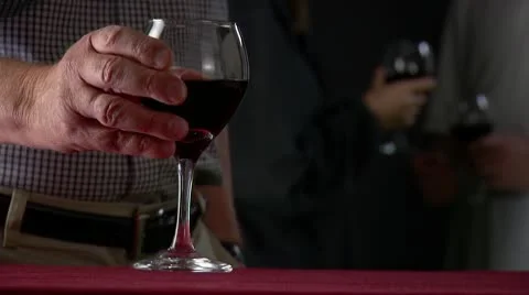Picking up wineglass Stock Footage 10605026