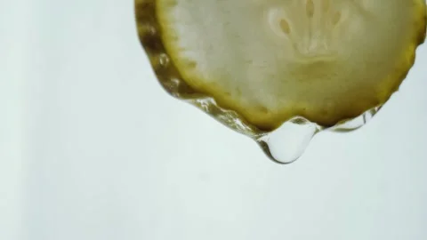 Pickle Slice Dripping with Liquid in a Macro Food Preparation Close Up Shot Stock Footage 331101029