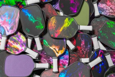 Pickleball many different multicolored rackets. Sports background Illustrazione stock