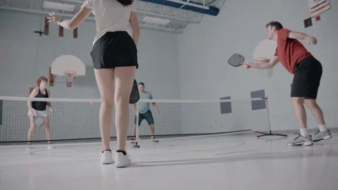 Pickleball team playing in a gym Stock Footage 299424601