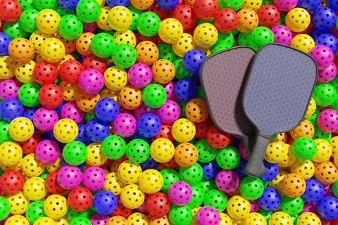 Pickleball. Two rackets lie on a large pile of multi-colored sports balls Illustrazione stock
