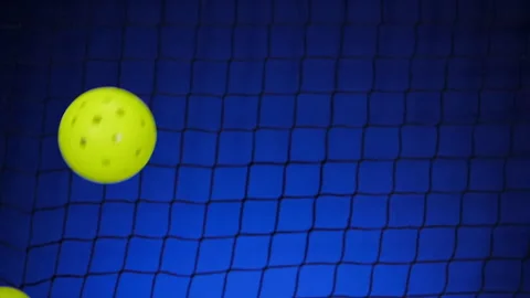 PICKLEBALLS BOUNCE IN AND OUT OF FRAME. 180 FPS.  NO PEOPLE. Stock Footage 263988697