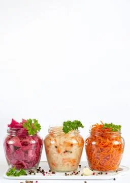 Pickled and fermented homemade vegetables. Sauerkraut, marinated red cabbage Stock Photos