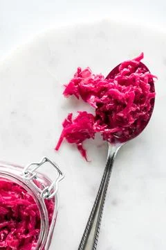 Pickled beet and red cabbage sauerkraut piled on a large spoon. Stock Photos