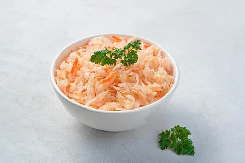 Pickled cabbage with fresh dill on a gray background. Stock Photos