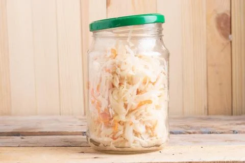 Pickled cabbage in a jar with opened cover Stock Photos