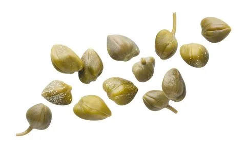 Pickled capers flying close-up on a white. Isolated Stock Photos