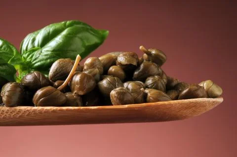 Pickled capers in the spoon  Stock Photos