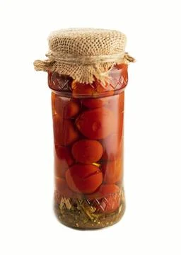 Pickled cherry tomatoes. Packaging cover made of burlap. Isolated on a white Stock Photos