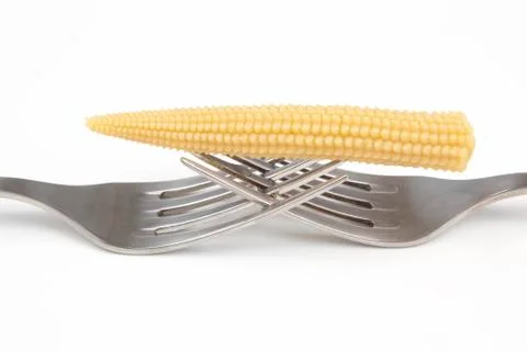 Pickled corn on a fork close-up on a whire background. food and vegetables Stock Photos