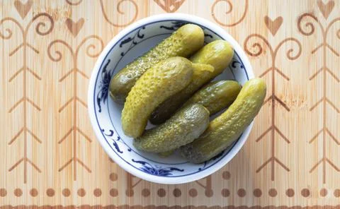 Pickled Cornichons in Vinegar on Ceramic cup. These powerful little cucumbe.. Stockfoto's