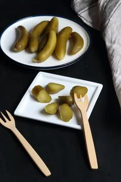Pickled cucumber on a black background Stock Photos