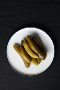 Pickled cucumber on a black background Stock Photos