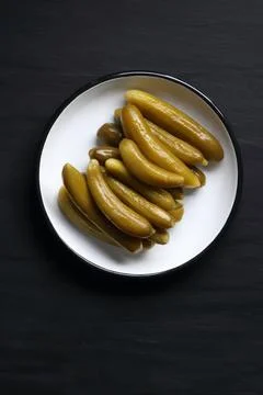 Pickled cucumber on a black background Stock Photos