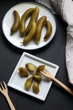 Pickled cucumber on a black background Stock Photos