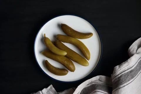 Pickled cucumber on a black background Stock Photos
