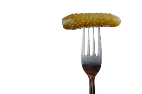 Pickled cucumber on a fork isolated on a white background Stock Photos