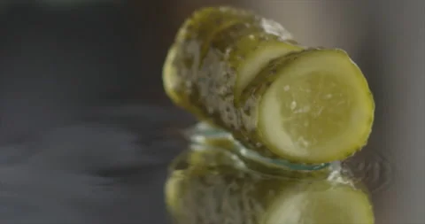 Pickled cucumber rolling on a mirror surface Video stock 197865921