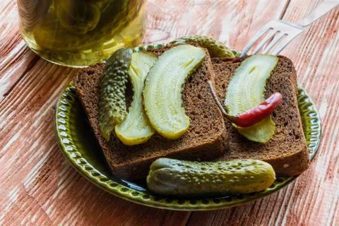 Pickled cucumbers and bread Stock Photos