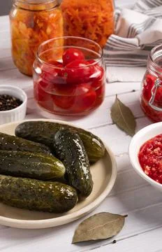 Pickled cucumbers and tomatoes on a table Stock Photos