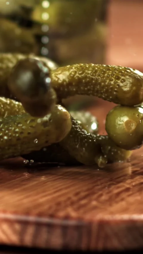 Pickled cucumbers fall on a cutting board. Filmed on a high-speed camera at 1000 Stock Footage 335374285