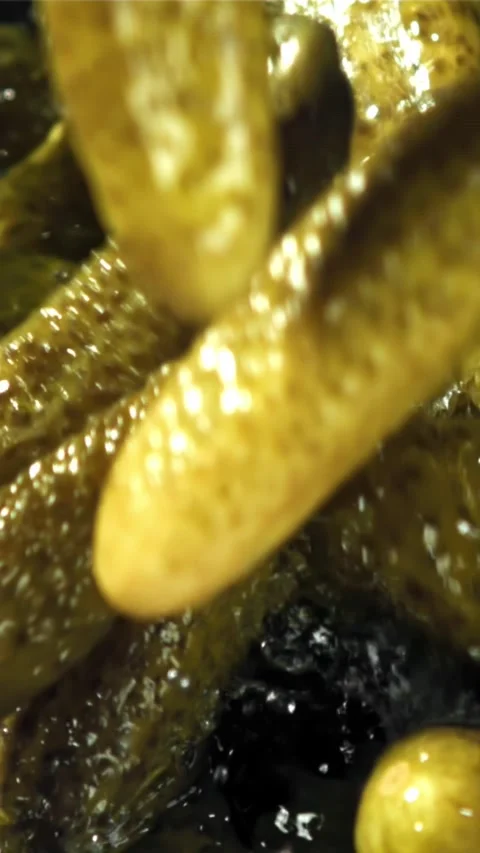 Pickled cucumbers fall with splashes. Filmed on a high-speed camera at 1000 fps Stock Footage 335359685