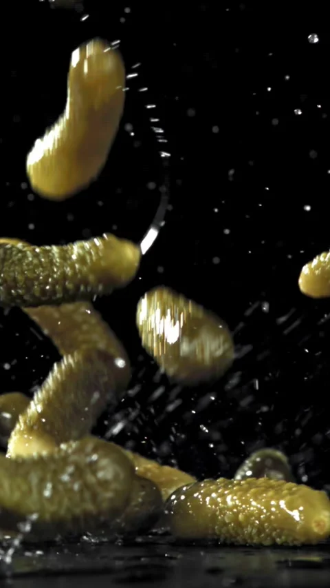 Pickled cucumbers fall on a wet table. Filmed on a high-speed camera at 1000 fps Stock Footage 335365924