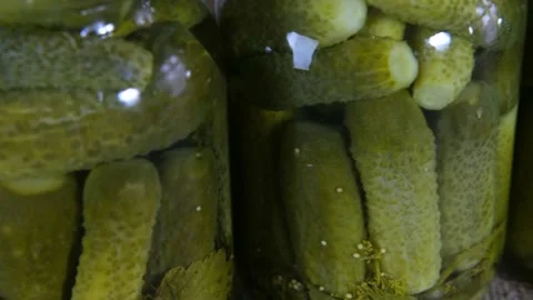 Pickled cucumbers with herbs and spices in glass jars. Homemade canned food. Stock Footage 168412794