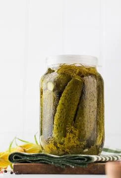 Pickled cucumbers in jars on a white background. Canning vegetables. Copy space. Foto stock