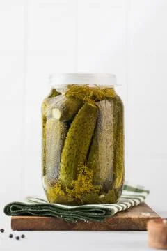 Pickled cucumbers in jars on a white background. Canning vegetables. Copy space. Foto stock