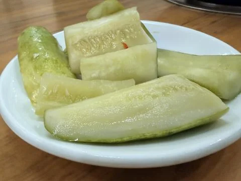Pickled Cucumbers on White Plate Fotos de archivo