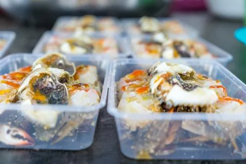 Pickled egg crab in plastic box for sale to tourists Stock Photos