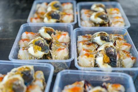 Pickled egg crab in plastic box for sale to tourists Stock Photos