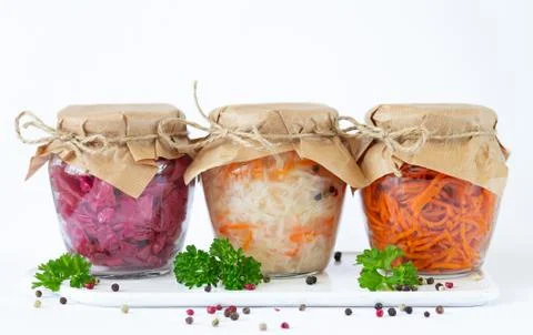 Pickled fermented vegetables in glass jars ready for eating Stock Photos