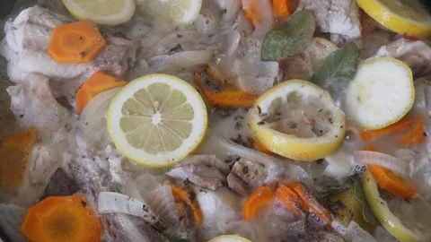 Pickled fish with lemon and vegetables boiling. 4K Stock Footage 325746771