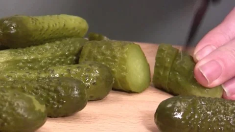 Pickled gherkin being thinly sliced 動画素材 72377016